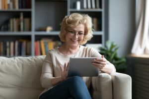 Older woman happily using a tablet